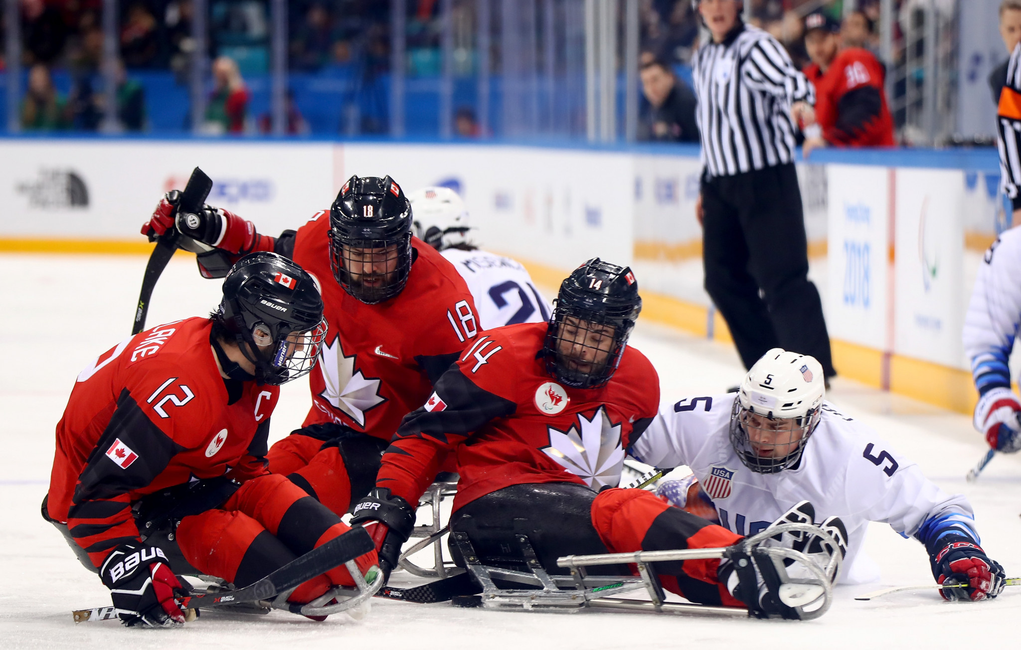 Canadian and American players battle for the puck in the Para-ice hockey final at the Gangneung Hockey Centre ©Getty Images