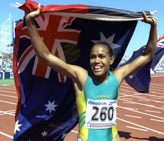 4. Cathy Freeman carries the Aboriginal and Australian flags on victory laps at Victoria 1994