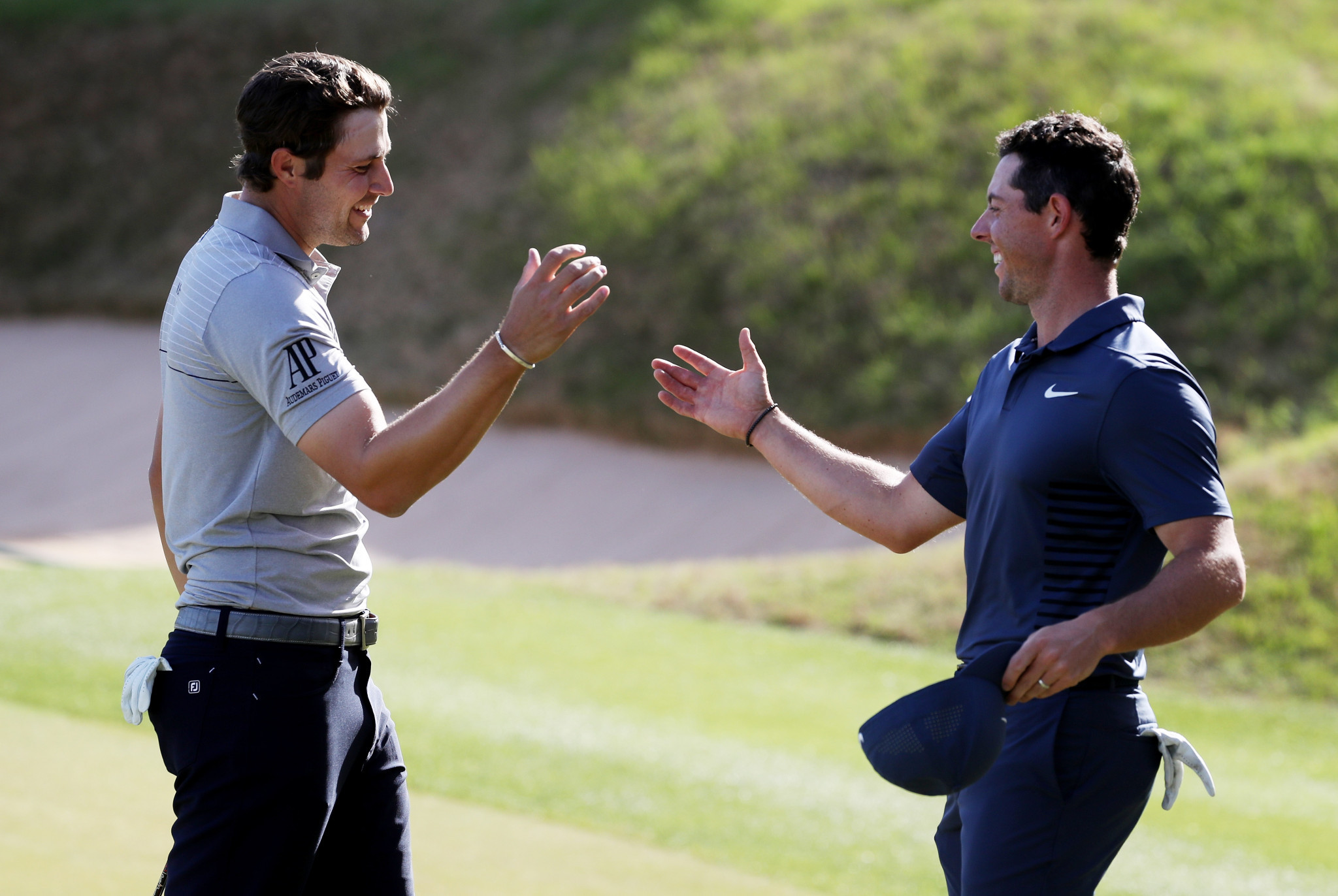 Peter Uihlein, left, is congratulated after beating Rory McIlroy, right ©Getty Images 
