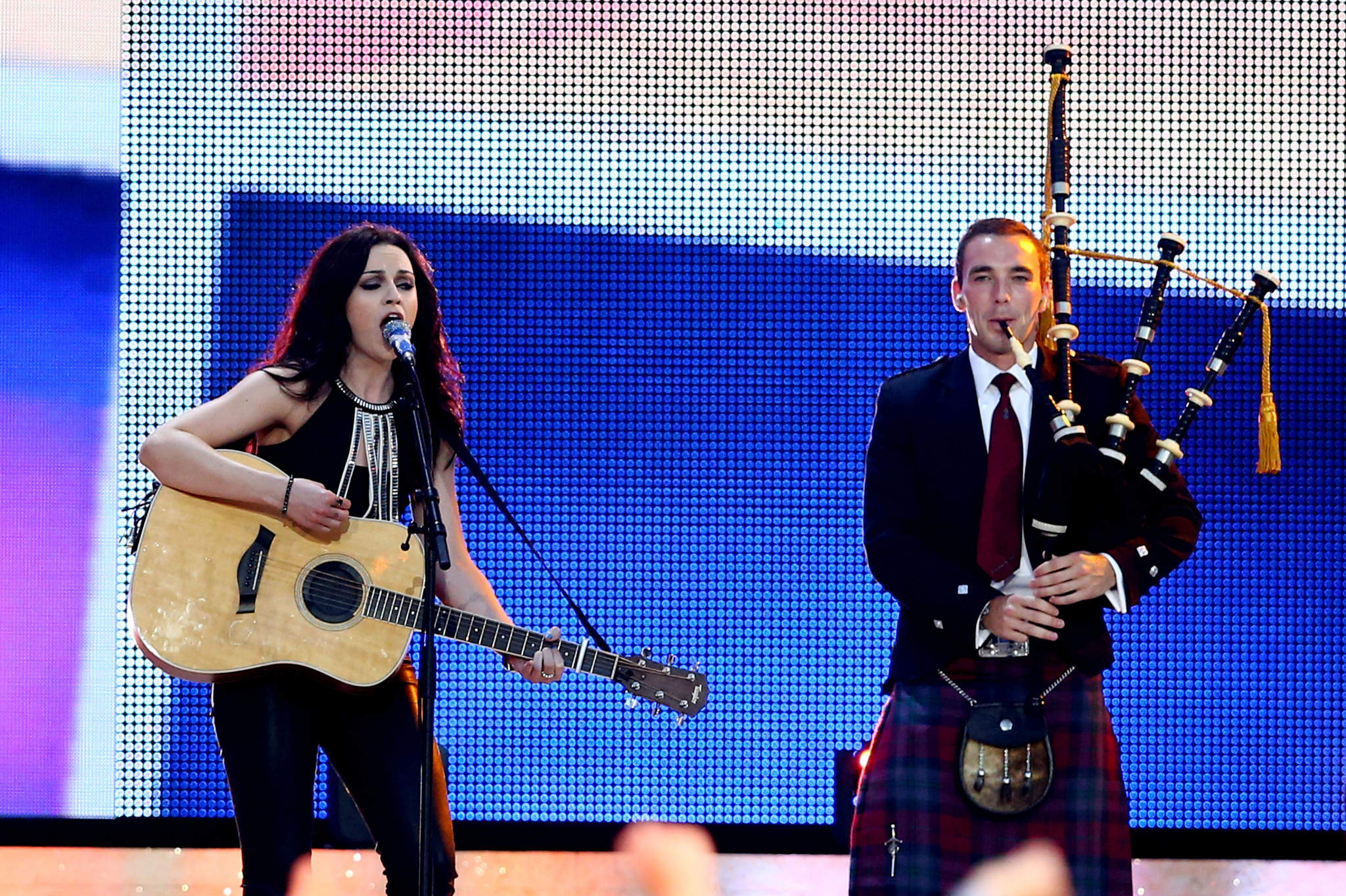 Amy Macdonald performs alongside a piper at the Glasgow 2014 Opening Ceremony ©Getty Images