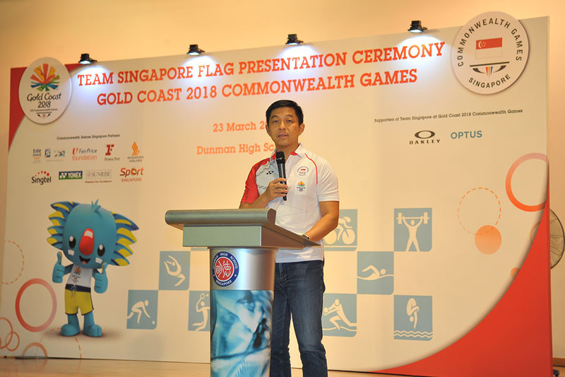 Singapore National Olympic Council President Tan Chuan-Jin handed his country's flag to shooter Teo Shun Xie during a special ceremony at Dunman High School ©SNOC