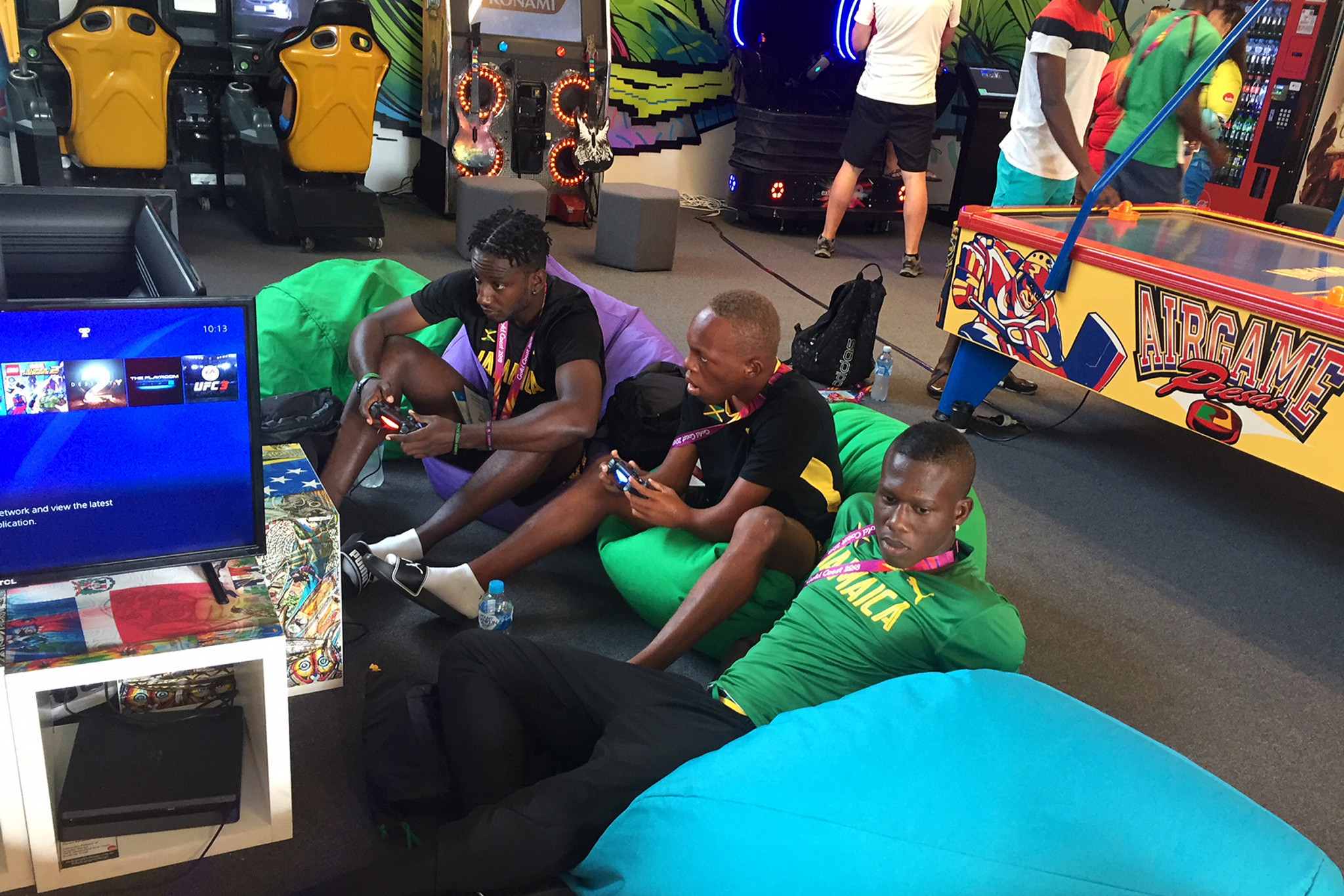 Jamaican athletes playing video games in the recreational room in the Athletes' Village ©Getty Images