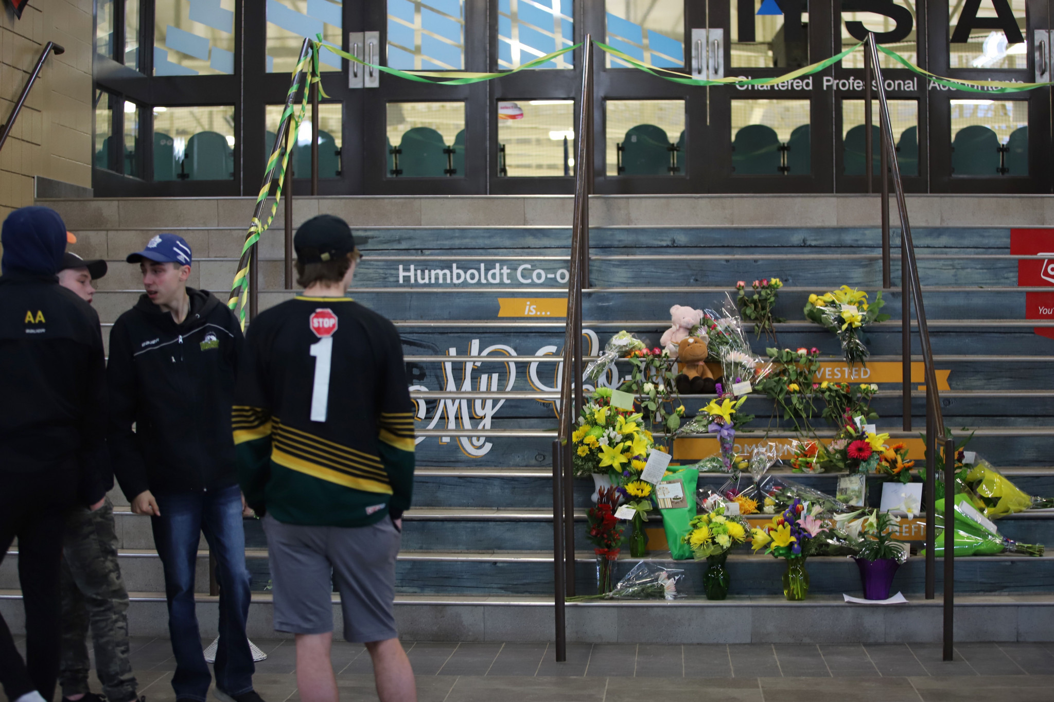 Flowers are left outside the Humboldt Uniplex ice-skating rink in Saskatchewan after a bus carrying a junior ice hockey team collided with a truck and killed 14 people