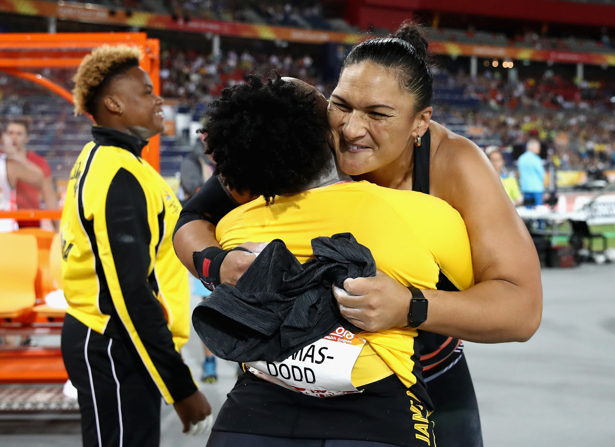 Jamaica's Danniel Thomas-Dodd and New Zealand's Dame Valerie Adams embrace after their shot put dual ©Getty Images