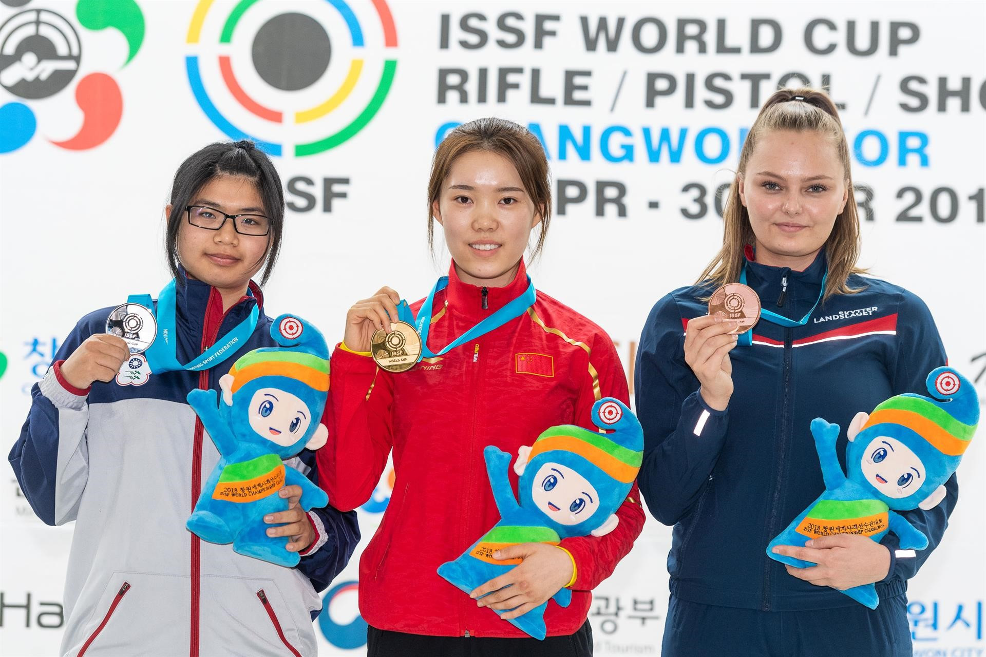 Zhao Ruozhu, centre, is flanked by the silver and bronze medallists, Chinese Taipei's Lin Ying-Shin and Norway's Jenny Stene after winning the women's 10m air rifle at the ISSF World Cup ©ISSF