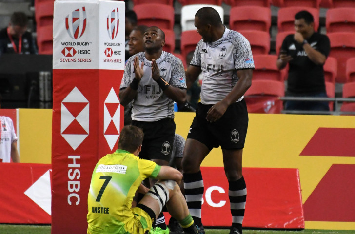 Fiji's Alasio Sovita Naduva, left, reacts after scoring a dramatic last second try against Australia that won his team a third consecutive World Rugby Sevens Series title in Singapore ©Getty Images