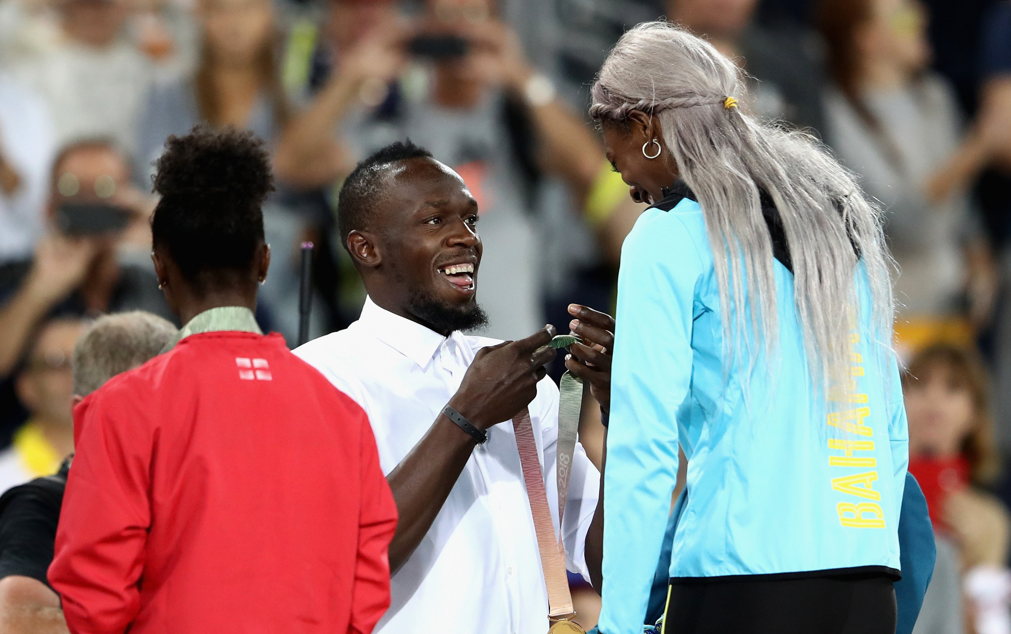 Shaunae Miller-Uibo, pictured receiving her Commonwealth 200m gold medal from Usain Bolt last month, will start the defence of her Diamond League title in Shanghai tomorrow ©Getty Images  