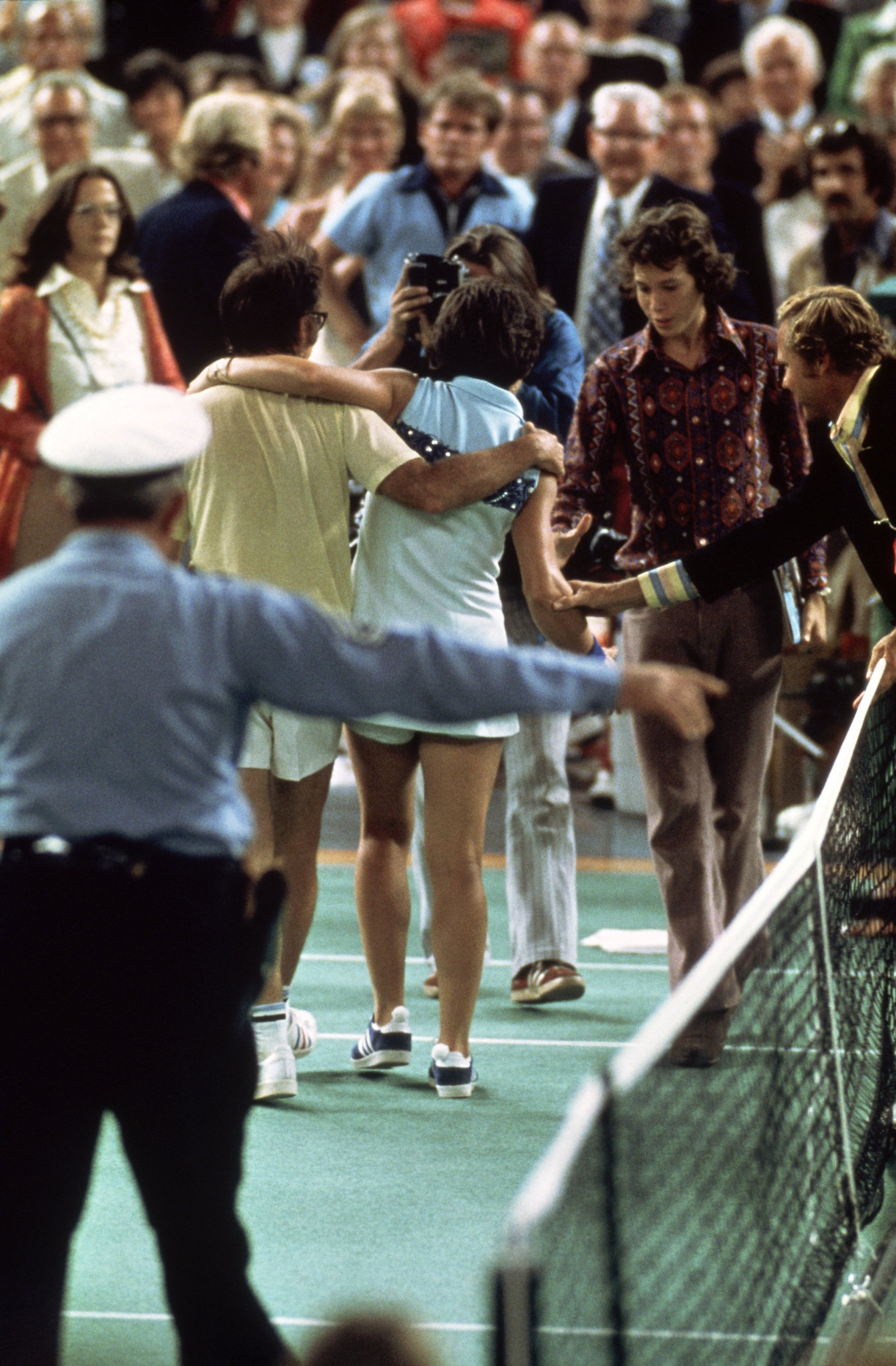 Bobby Riggs and Billie Jean King leave the Houston Astrodome court after the latter's 6-4, 6-3, 6-3 win ©Getty Images  