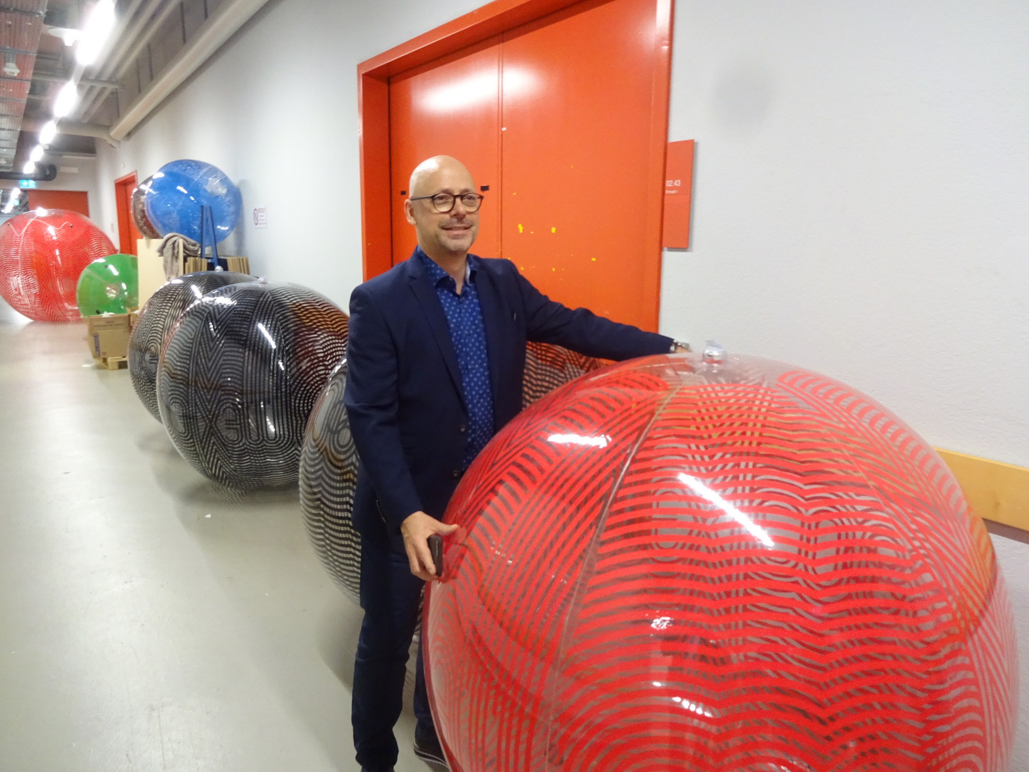 Curator Markus Osterwalder with a giant ball from Mexico 1968 before it was installed in the exhibition ©Philip Barker