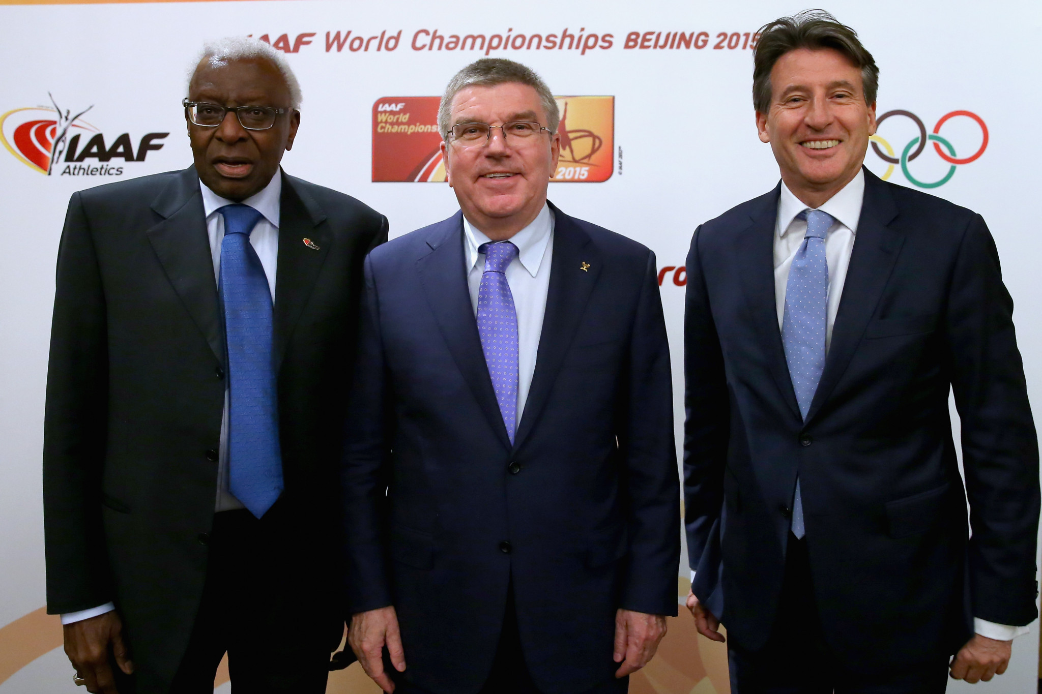 Lamine Diack, left, and Sebastian Coe, right, either side of IOC President Thomas Bach in 2015 ©Getty Images