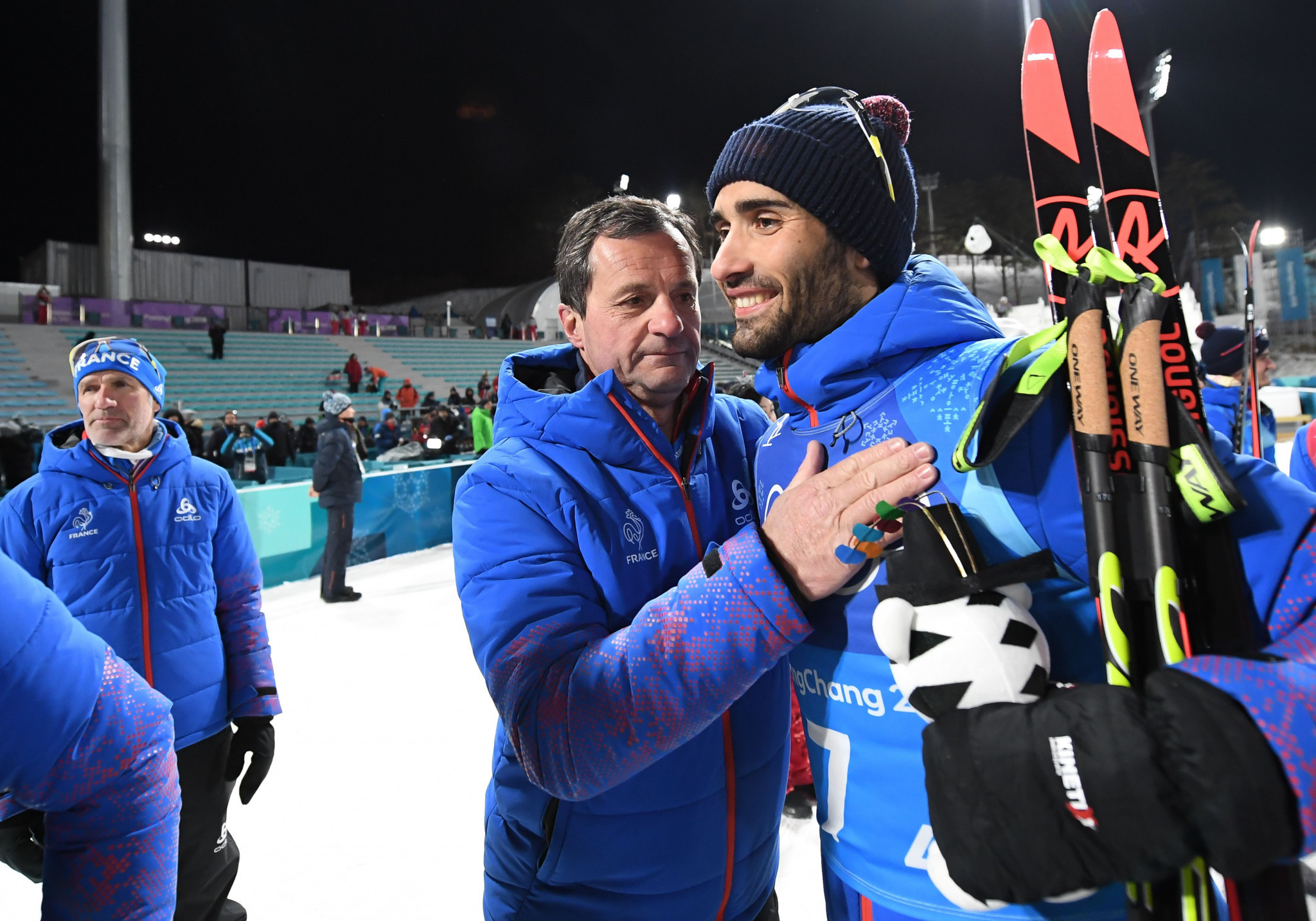 Michel Vion, centre, congratulates French biathlete Martin Fourcade during Pyeongchang 2018 ©Getty Images