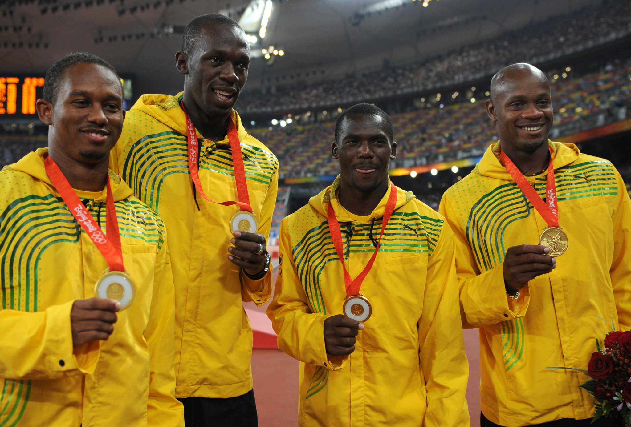 Nesta Carter, third left, celebrates along with his Jamaican team-mates at Beijing 2008 ©Getty Images