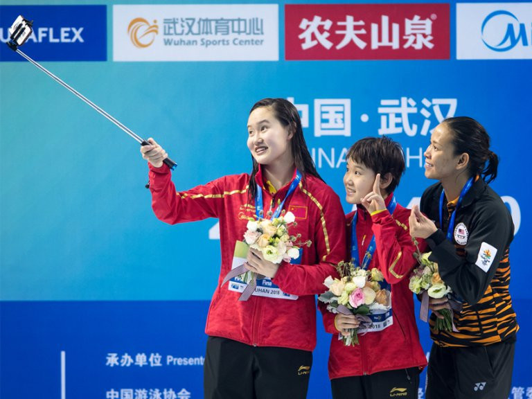 The three medallists pose together on the podium ©FINA