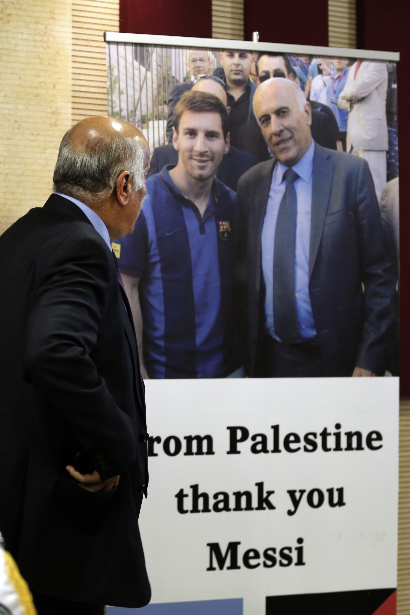 Palestine football boss Jibril Rajoub stands in front of a sign addressed to Argentina's star player Lionel Messi, left ©Getty Images