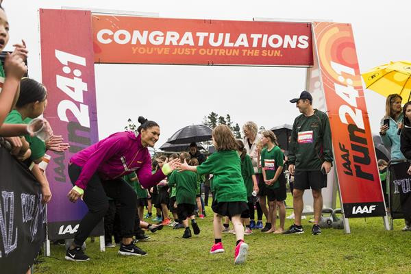 New Zealand's double Olympic shot put champion Valerie Adams congratulates finishers in the IAAF Run 24:1 run in Auckland - the event which started the new challenge ©IAAF