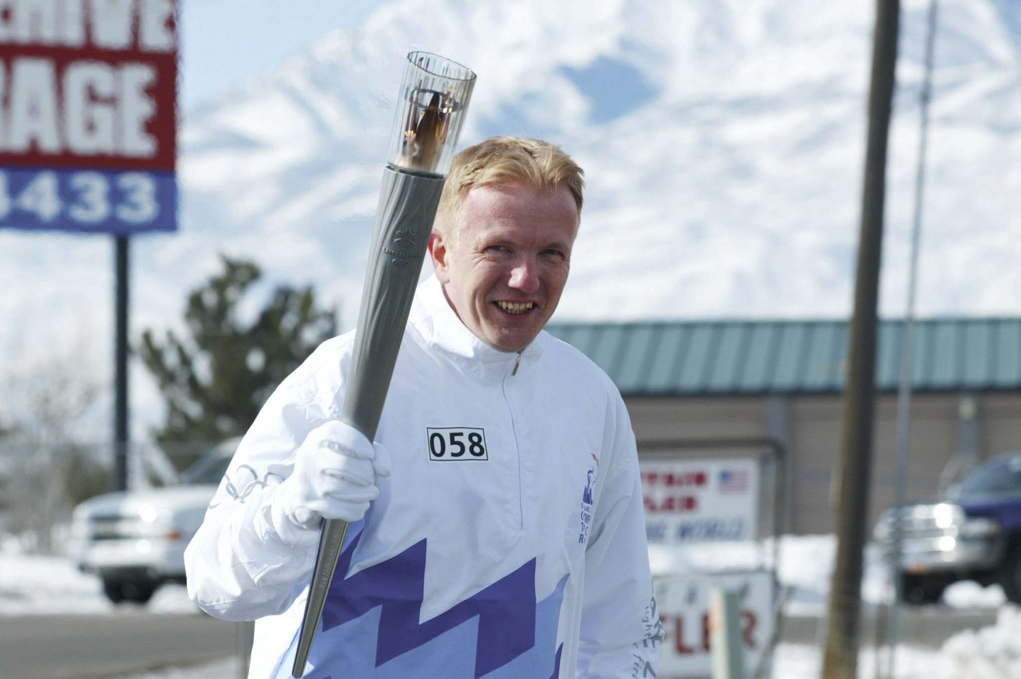 Roland Baar pictured carrying the Olympic Torch before the Salt Lake City 2002 Olympics ©Getty Images