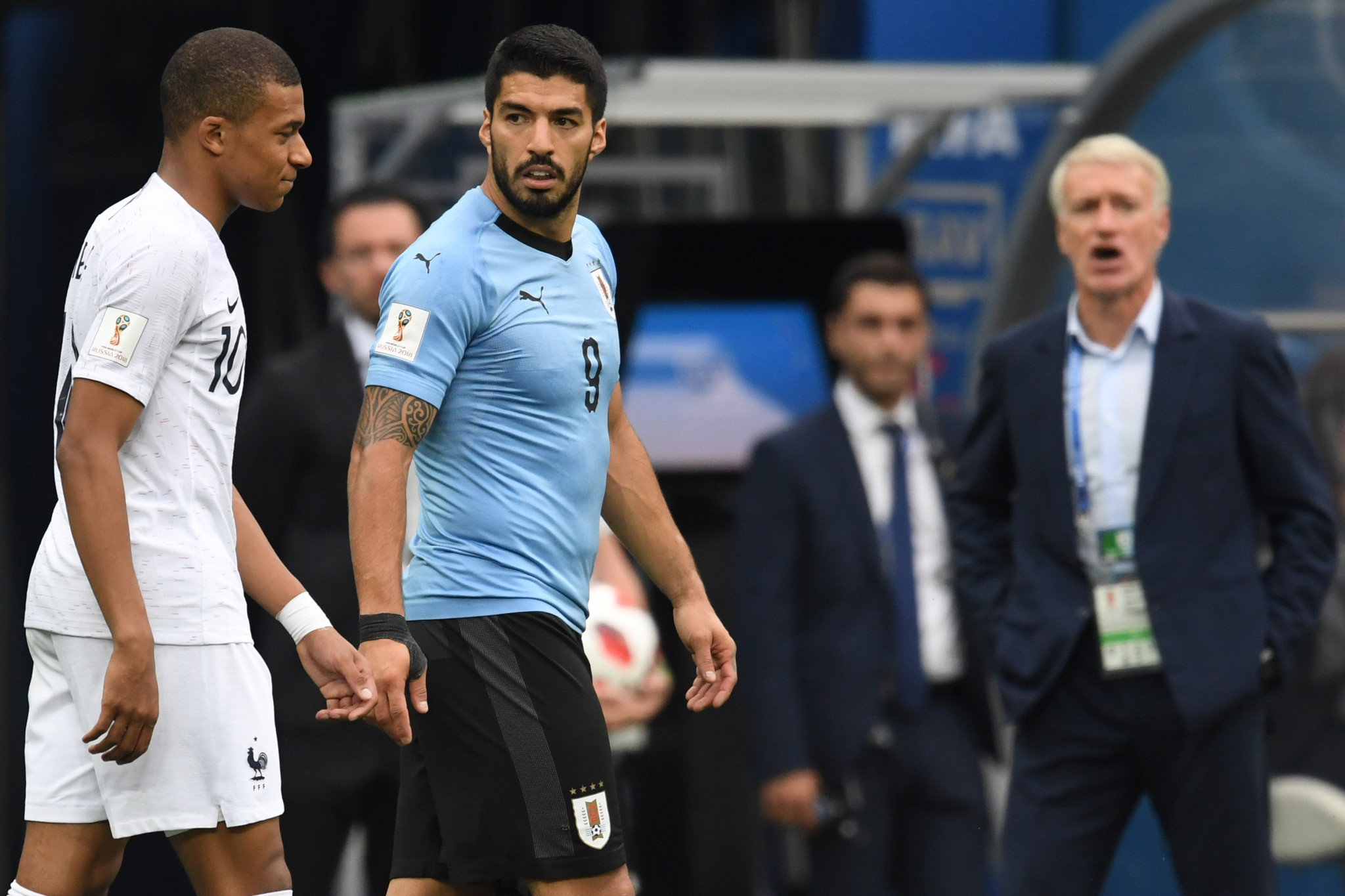 French forward Kylian Mbappe, left, argued with Luis Suarez during the quarter-final clash ©Getty Images
