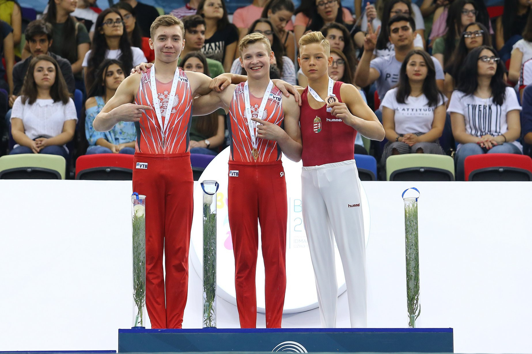 Russia's Iurii Busse, centre, came out on top in the boys' event ©FIG