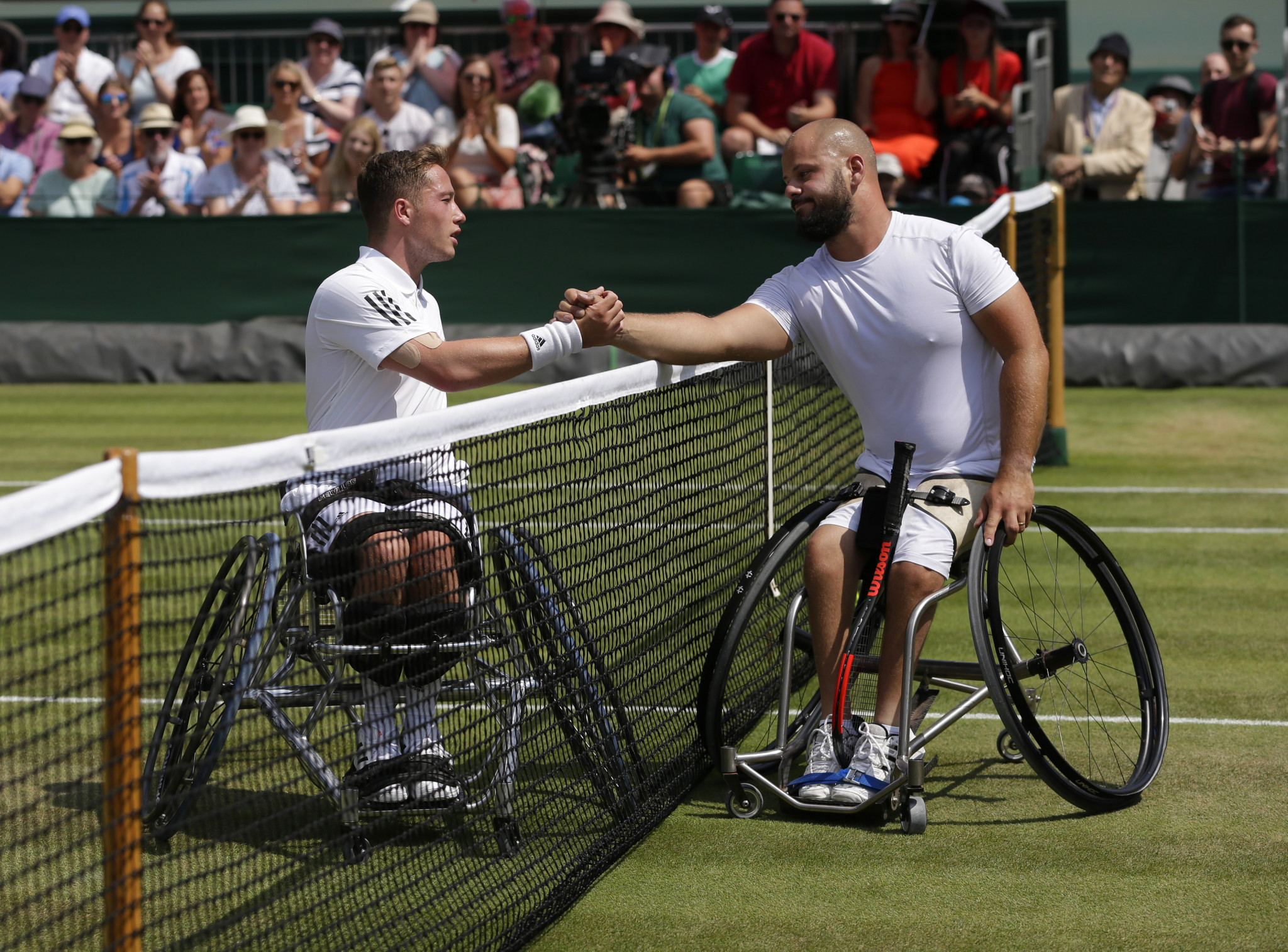 Britain's Alfie Hewitt, left, and defending champion Peter Olsson shake hands after their wheelchair men's singles semi-final at Wimbledon ©Getty Images  