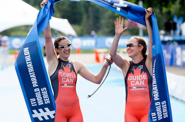 Canada's Jessica Tuomela and her guide Lauren Babineau celebrate victory in the women's visually impaired race at the ITU Para-triathlon World Cup in Magog, Quebec ©ITU