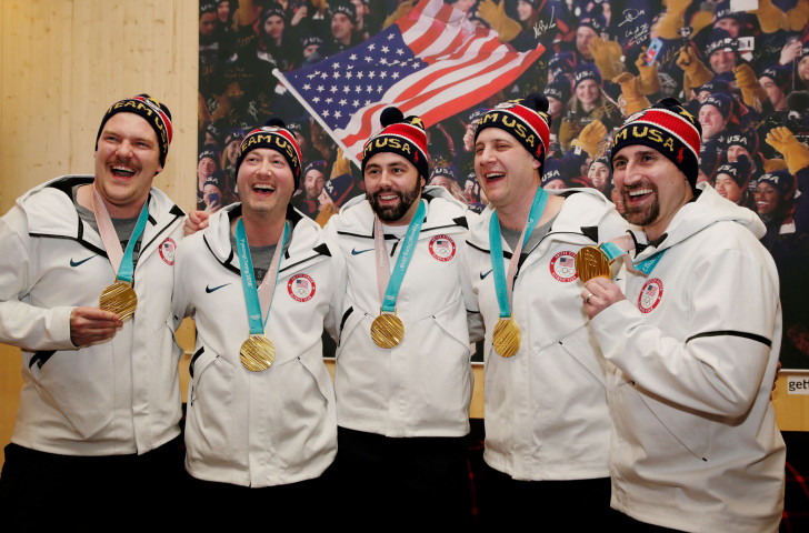 John Landsteiner, pictured, centre, with fellow US curling gold medallists at the Pyeongchang 2018 Games, is to be re-united with the commemorative Olympic ring he lost on a California beach following a metal detector discovery ©Getty Images  