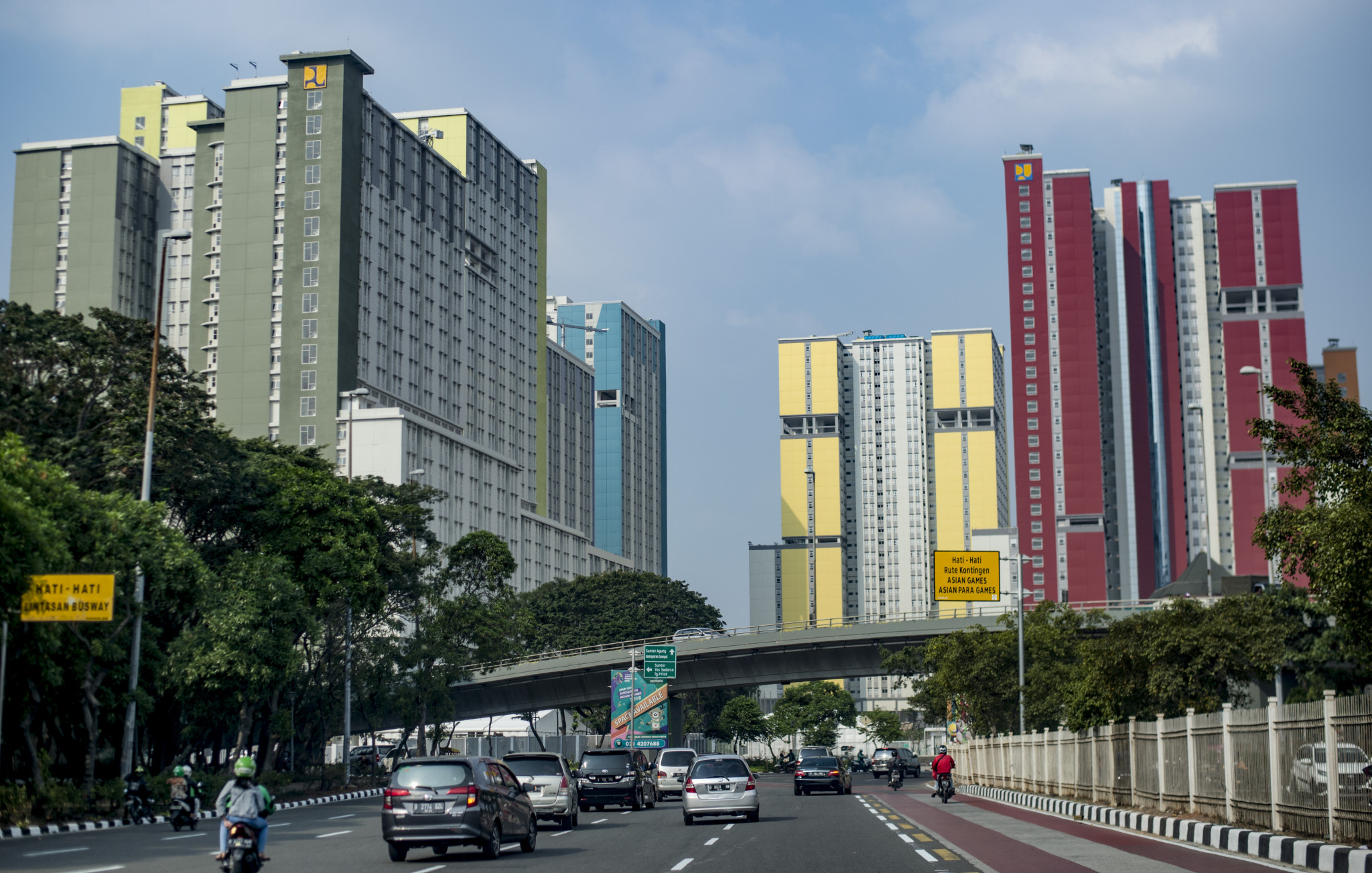 Traffic commutes next to the newly-completed Asian Games Athletes' Village in Kemayoran district, central Jakarta - it is hoped closing schools during the event will help reduce congestion ©Getty Images