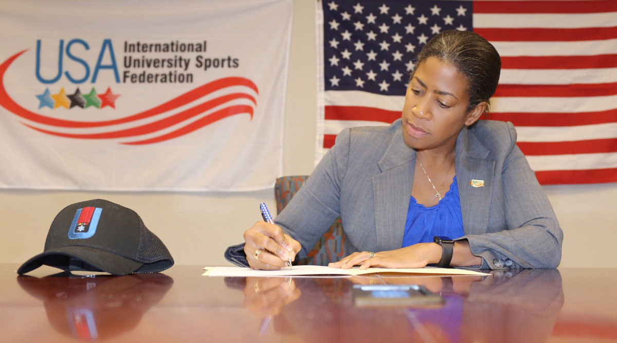 Delise O'Meally, secretary general of the United States' National University Sports Federation, signs the host city agreement ©FISU