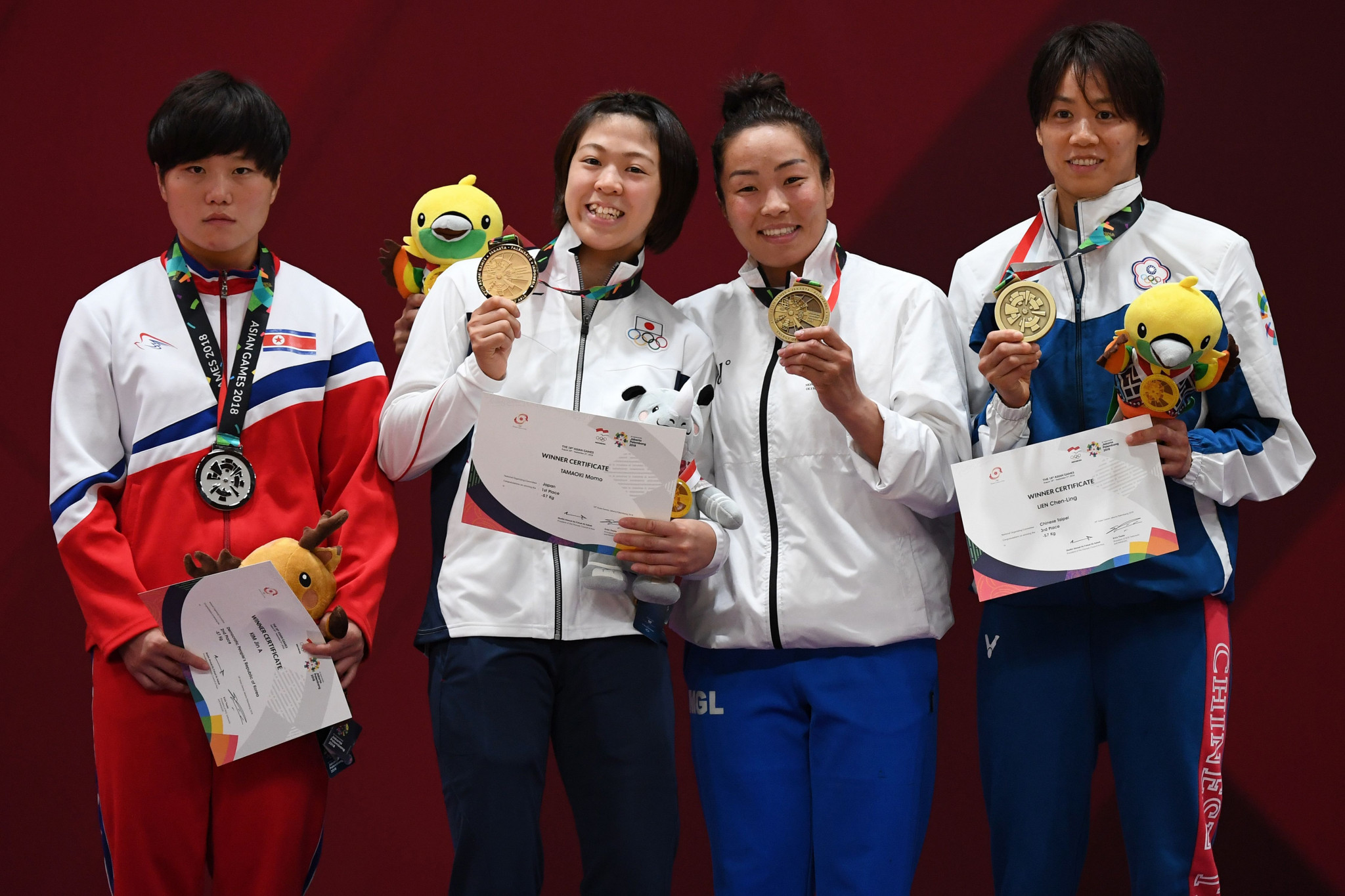 Momo Tamaoki, second from left, was one of four judo gold medallists for Japan today, winning the women's under-57 kilograms title ©Getty Images