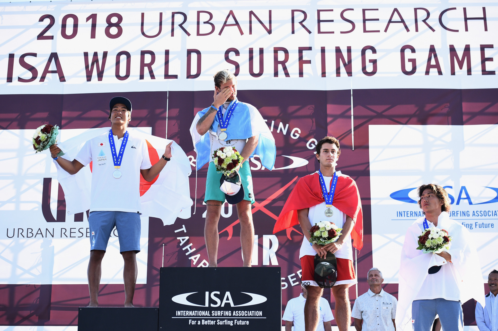 Santiago Muñiz of Argentina, Kanoa Igarashi, of Japan, Lucca Mesinas of Peru and Shun Murakami of Japan on the podium after earning medals at the ISA World Surfing Games in Tahara in Japan ©Getty Images