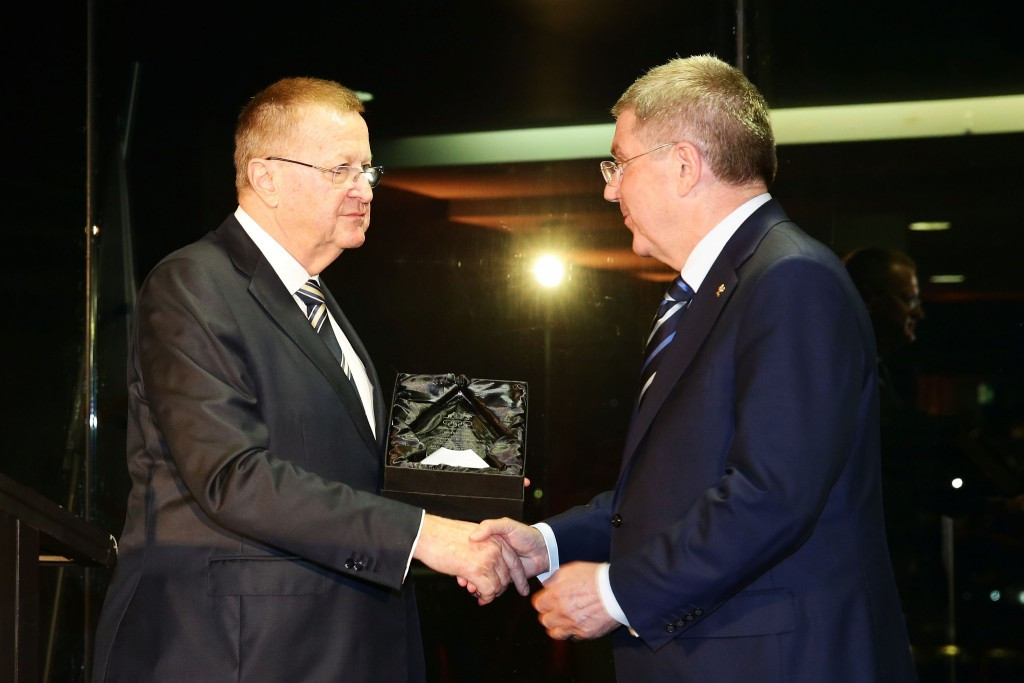 Thomas Bach receiving the IOC Order of Merit Award from AOC counterpart, and IOC vice-president, John Coates 