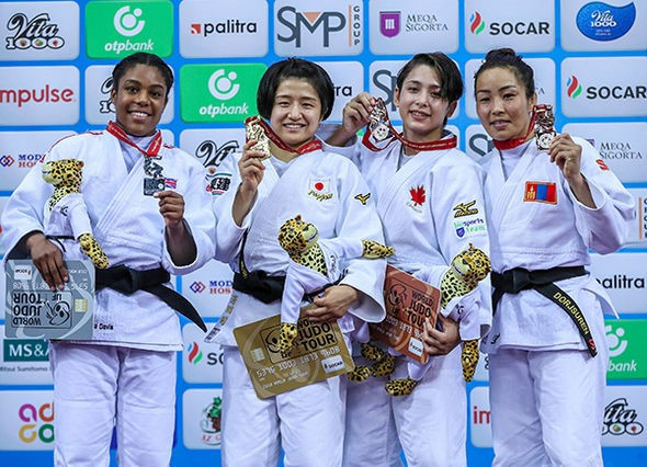 The women's under-57kg medallists smile with their medals ©IJF