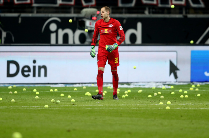 Peter Gulacsi, goalkeeper of RB Leipzig, picks up tennis balls from the field during a Bundesliga match with Eintracht Frankfurt in February this year, when fans protested at a change of timing of the fixture ©Getty Images  