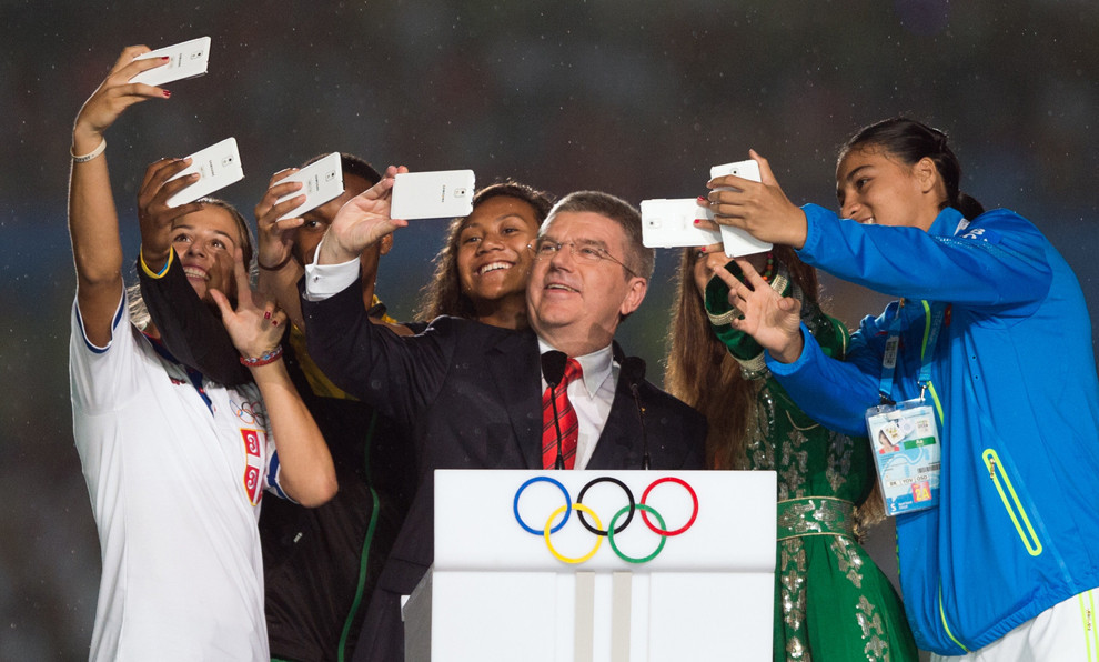 IOC President Thomas Bach poses with athletes at the 2014 Youth Olympic Games in Nanjing to take a 