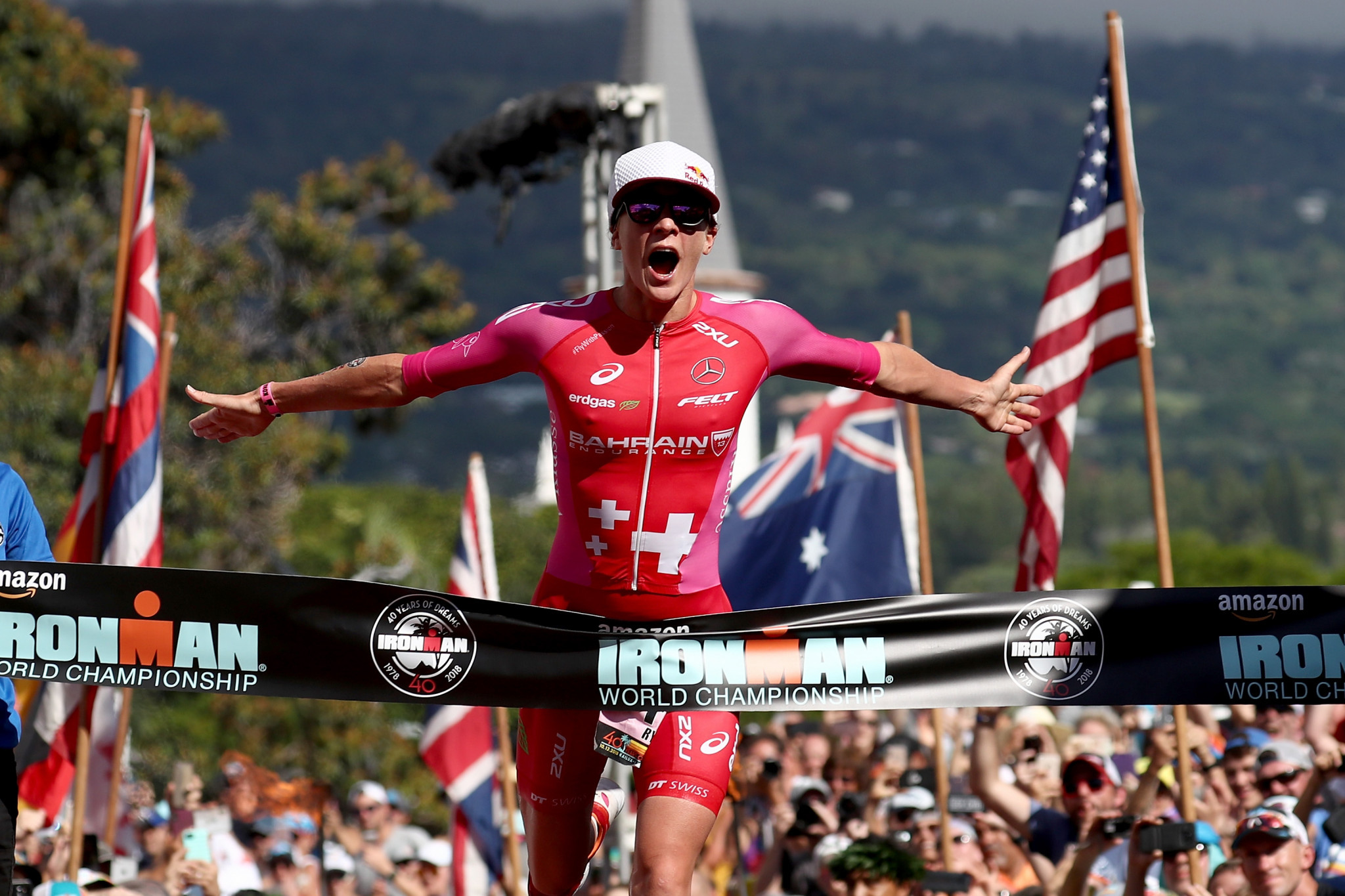 Daniela Ryf of Switzerland celebrates winning the Ironman World Championship, setting a course record despite being stung by a jellyfish just before the event began ©Getty Images