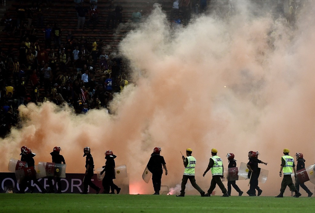 Smoke and flare bombs were let off by angry Malaysian supporters which caused their match with Saudi Arabia to be abandoned