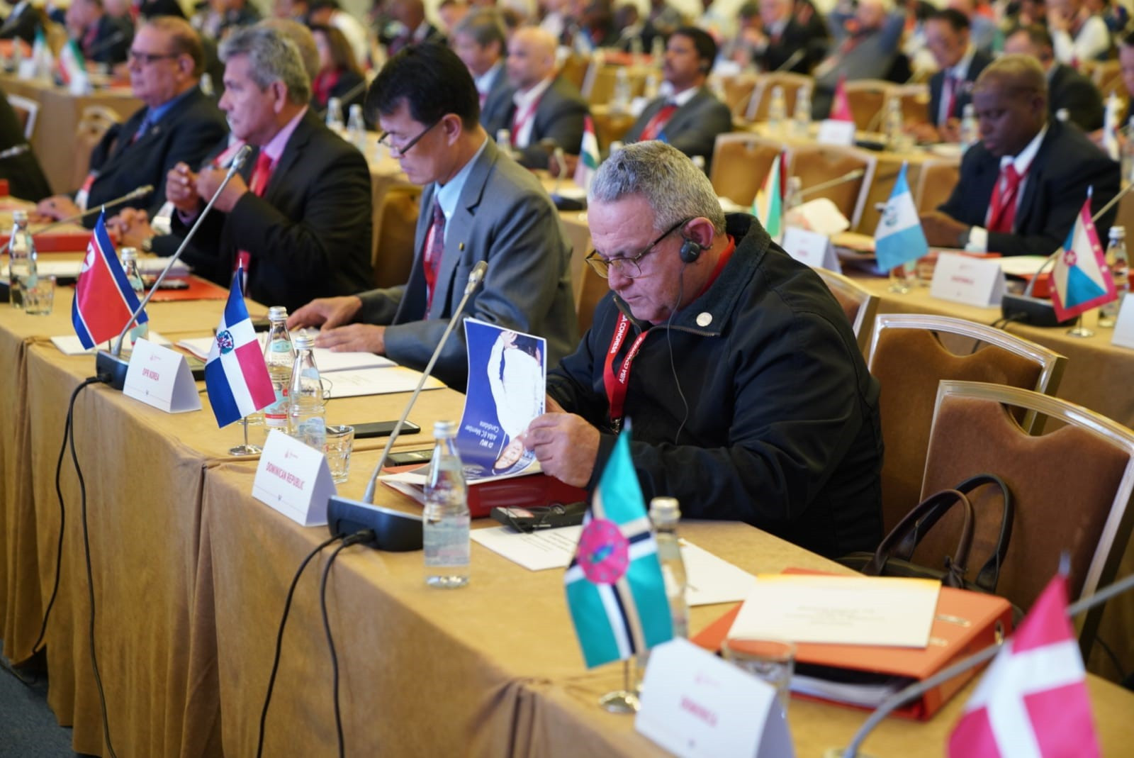 A delegate reads the election manifesto of AIBA Interim President Gafur Rakhimov, who is seeking the position on a permanent basis ©AIBA