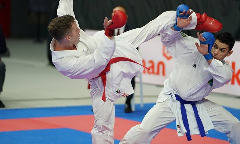 Vinicius Figueira of Brazil, right, did enough to reach the under-67kg final ©WKF