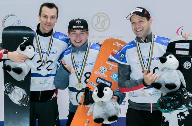 Chris Vos, centre, celebrates his second gold in the men's banked slalom SB-LL1 category at the first World Para Snowboard World Cup event to be held in Dubai ©World Para Sport