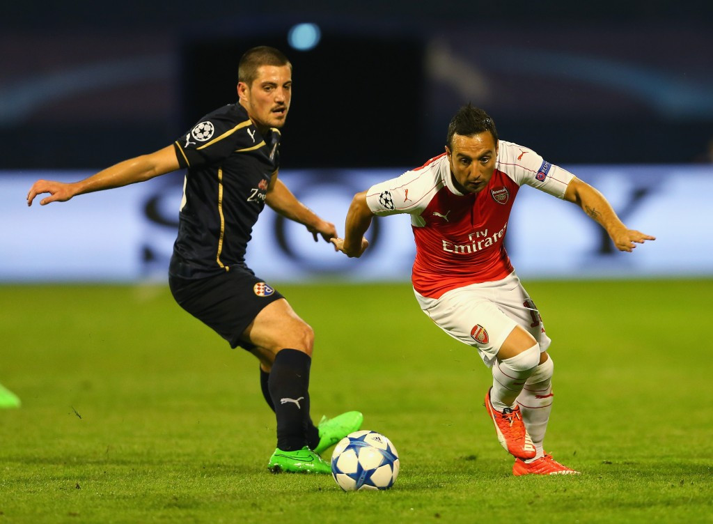 Arijan Ademi pictured attempting to tackle Arsenal's Santi Cazorla during the Champions League group match ©Getty Images