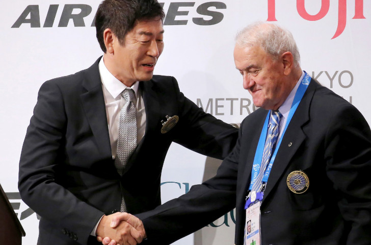 Morinari Watanabe shakes the hand of Bruno Grandi, whom he replaced as FIG President in October 2016, since when he has pursued a dynamic but divisive series of initiatives ©Getty Images  