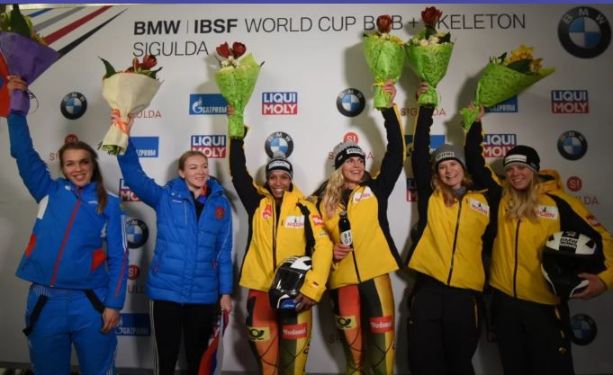 Olympic women’s bobsleigh champion Mariama Jamanka, third left, pictured with her brakewoman Annika Drazek, celebrates a first IBSF World Cup win with a track record in Sigulda, Latvia ©IBSF