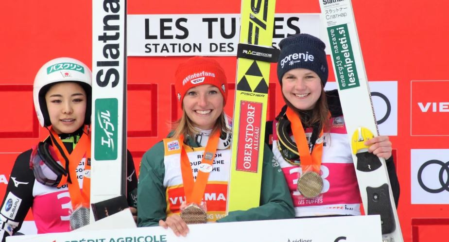 Germany's Katharina Althaus on the podium after her Ski Jumping World Cup victory in Premanon, France ©FIS