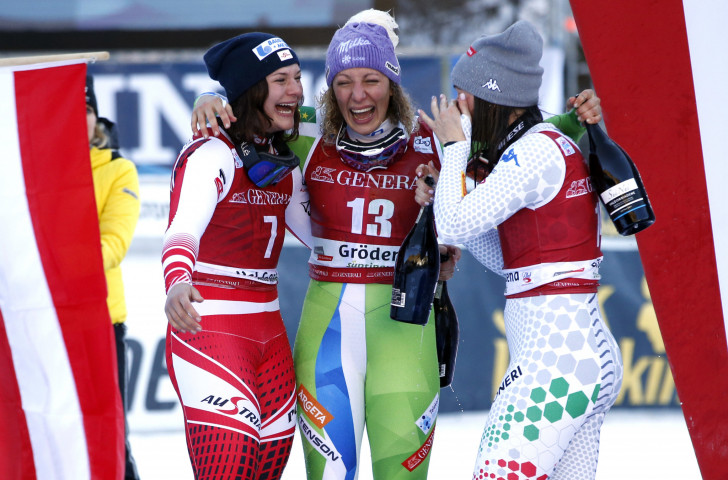 Ilka Stuhec of Slovenia, back after a 20-month absence through injury, celebrates victory in the FIS World Cup downhill in Val Gardena with her fellow medallists ©Getty Images