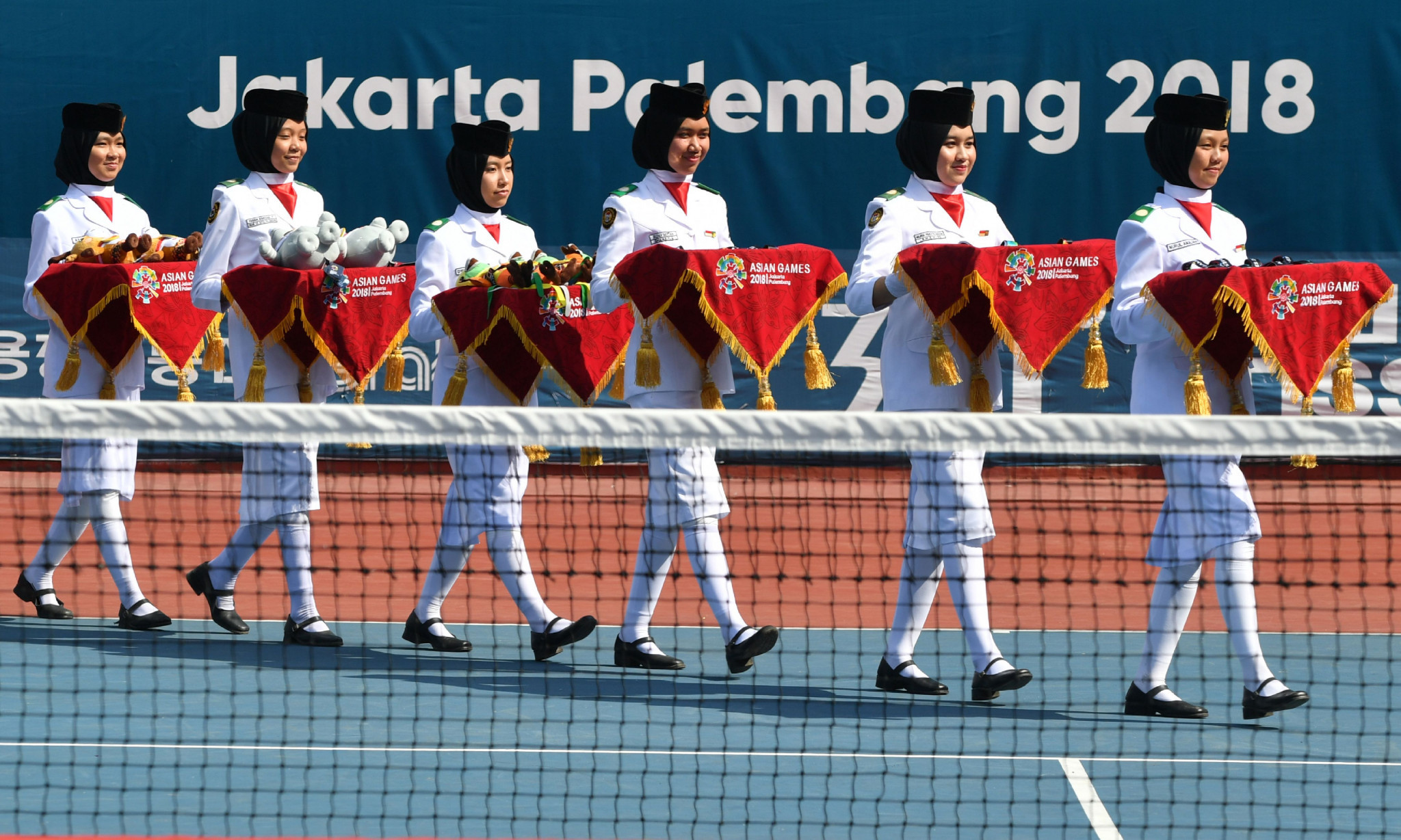 Indonesian students take part in the awards ceremony for the mixed doubles soft tennis event ©Getty Images