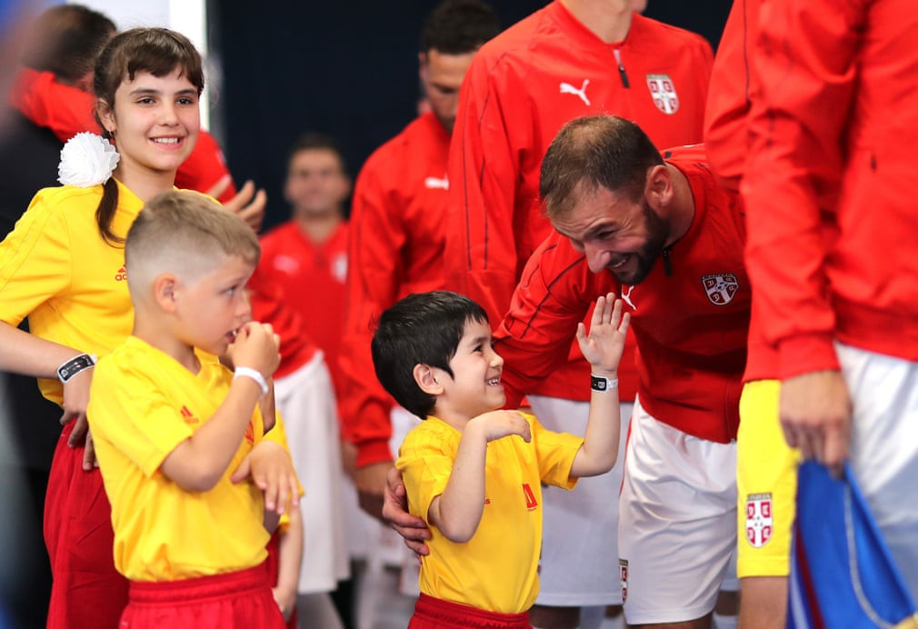 
Serbia's Branislav Ivanovic lets a young mascot tickle his beard ©Getty Images