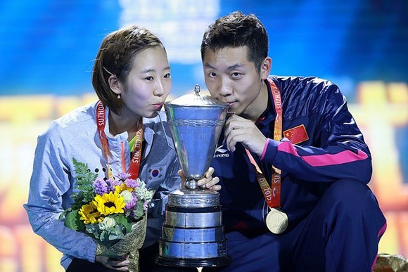South Korea's Yang Haeun (left) and China's Xu Xin (right) celebrate their mixed doubles success ©ITTF