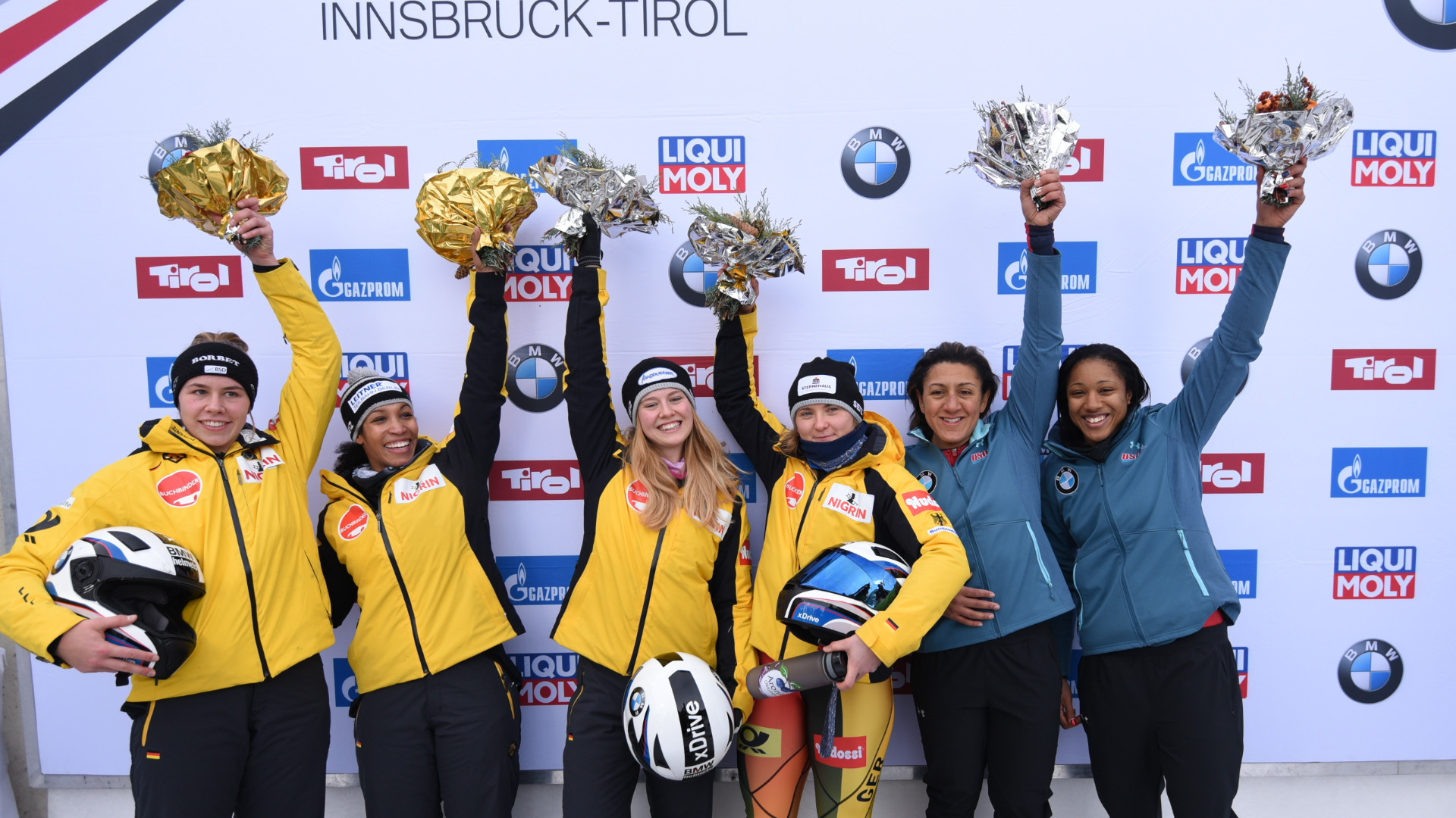 Germany's Stephanie Schneider, third right, and partner Ann-Kristin Strack top the podium at the IBSF women's bobsleigh World Cup event in Innsbruck ©IBSF