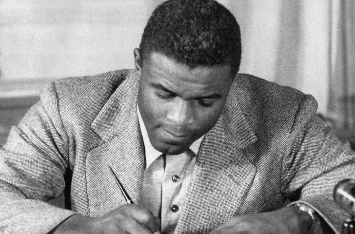 Jackie Robinson signs a contract to play for Brooklyn Dodgers, making him the first African American to play MLB ©Getty Images