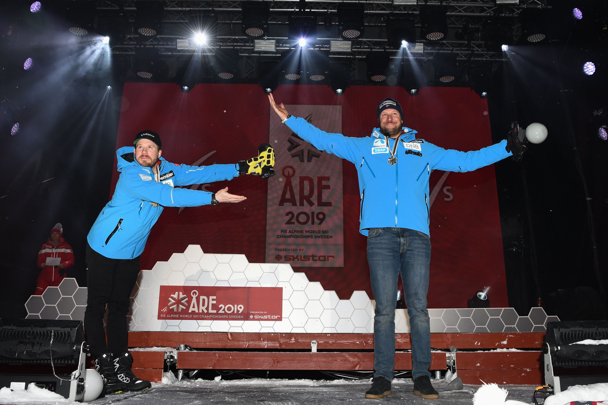 Silver medallist Svindal presented the winner to the crowd at the medal ceremony ©Getty Images