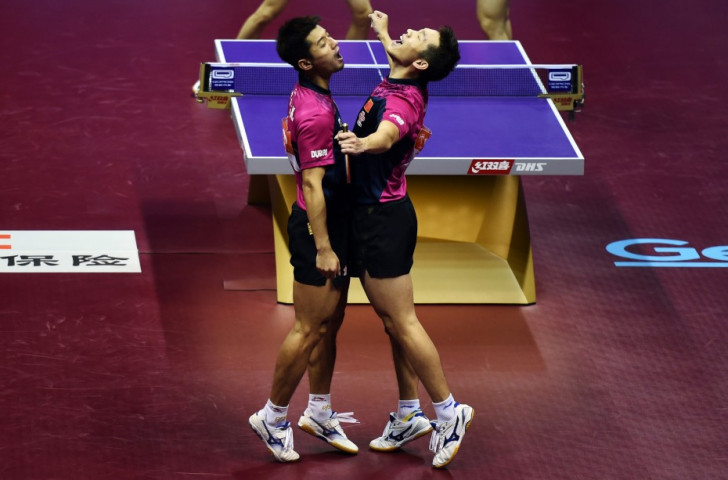 Xu Xin and Zhang Jike celebrate after winning the men's doubles title